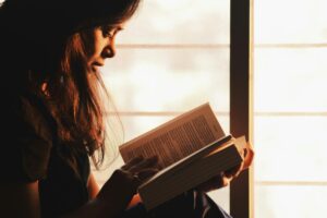 A girl studying a book with concentration during home tuition in Islamabad