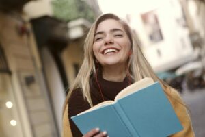 Smiling girl holding a book after home tuition session, showing confidence and success through City Tutors Academy tutoring services in Islamabad and Rawalpindi