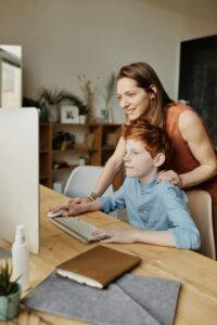 A professional home tutor in Islamabad teaching computer science to a young student during a personalized home tuition session, explaining coding concepts on a laptop. An example of how private tutor in home schooling helps.