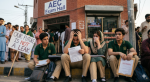 Group of worried O and A-Level students standing outside a school examination hall in Pakistan, looking anxious and stressed due to sudden news of Cambridge exam paper leaks.
